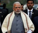 FILE PHOTO -  Prime Minister Narendra Modi walks to speak with t
